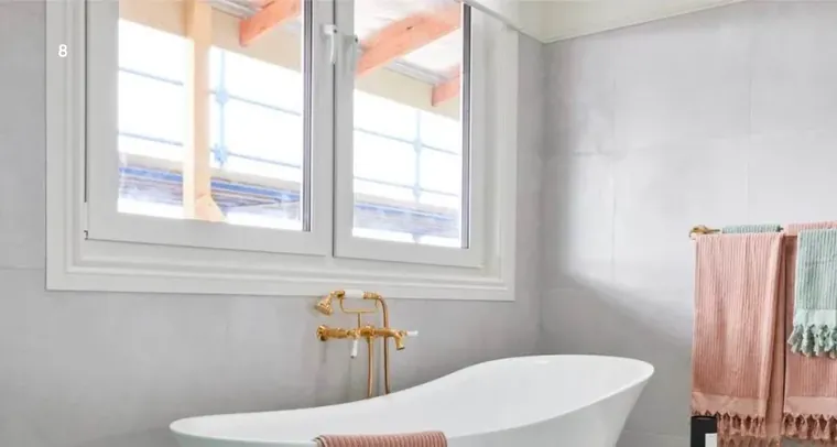 Premier uPVC casement windows opening above a freestanding bath